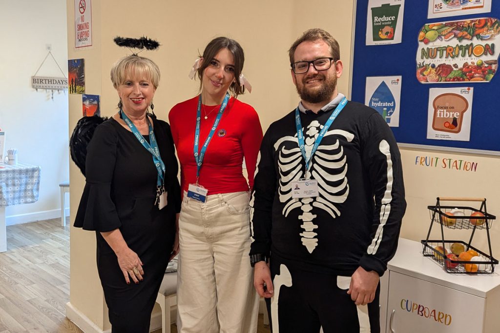 three team members in halloween costume