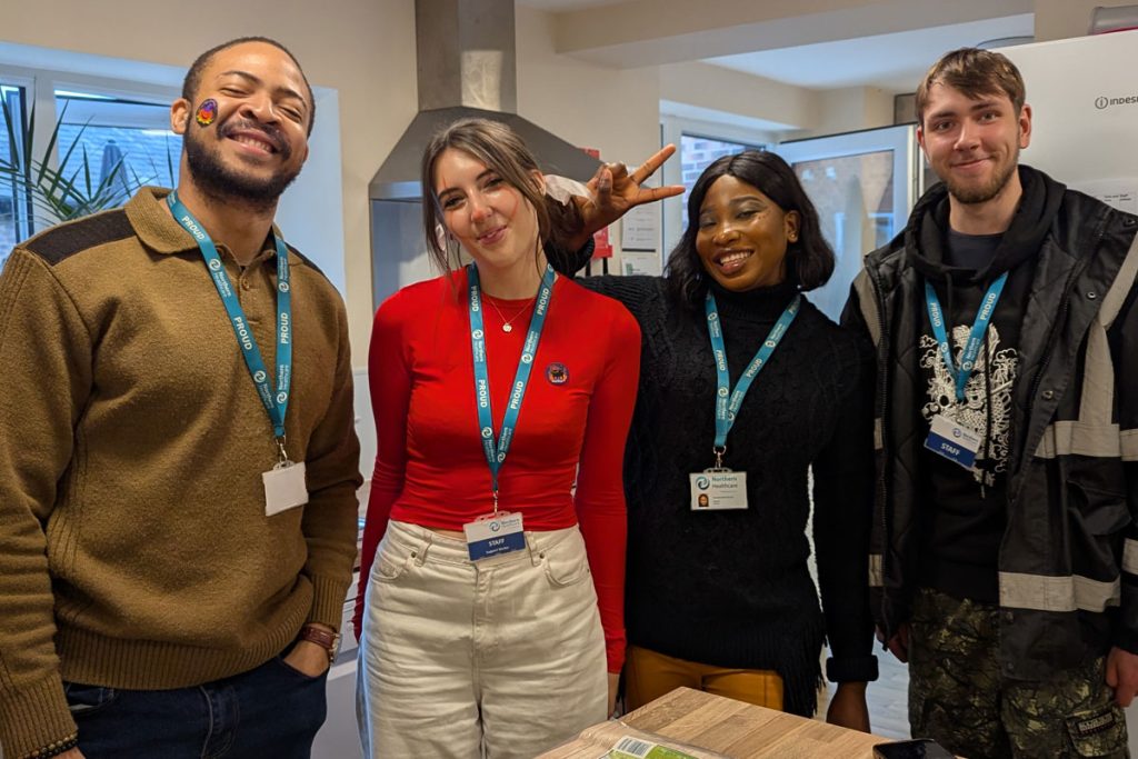 four team members posing in the kitchen