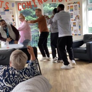 Group of people participating in Inclusion conga line