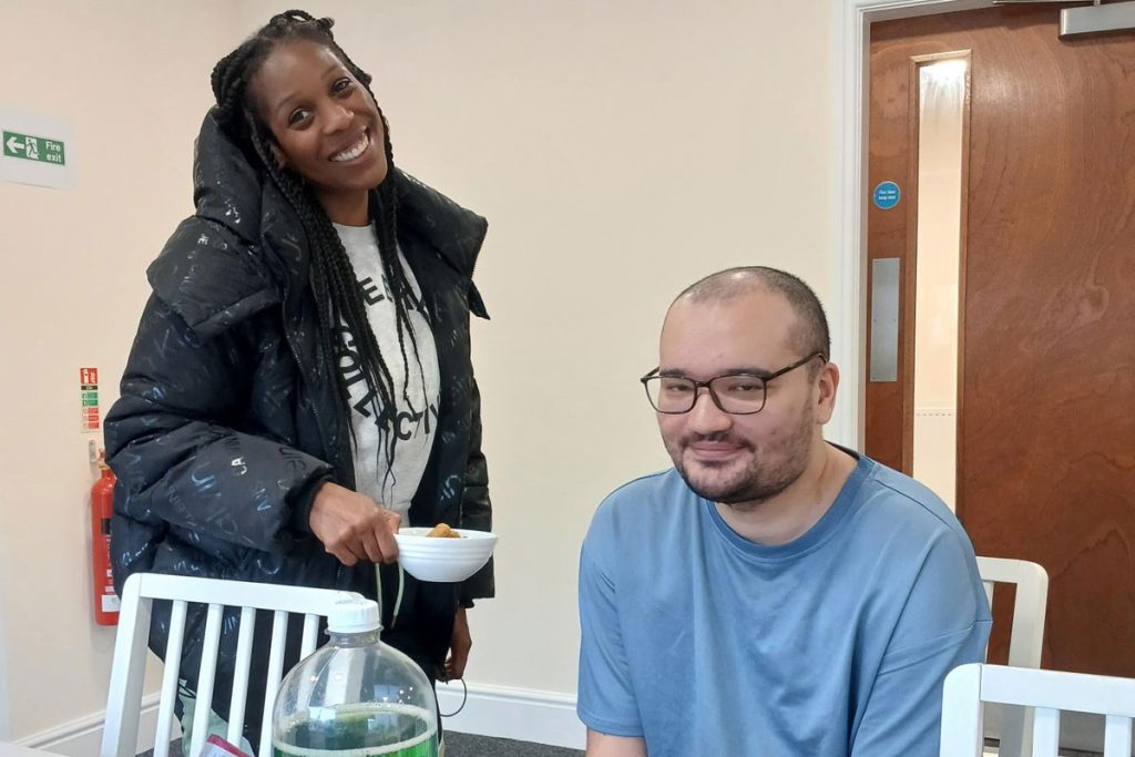 Male and female enjoying cakes and coffee