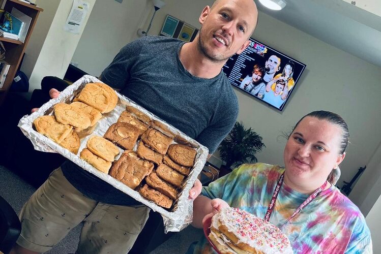 residents holding tray of homemade bakes