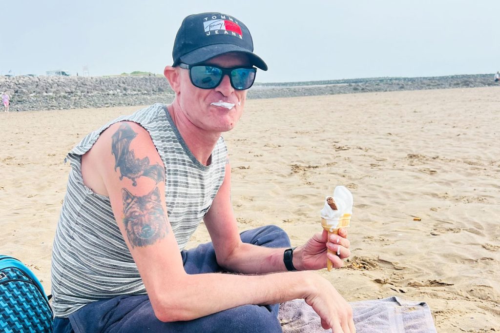 Gentleman having ice cream on the beach
