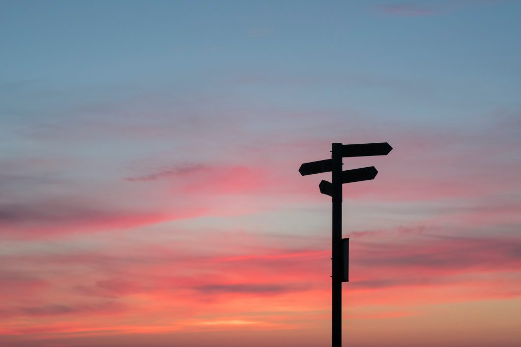 A sign post at sunset to help someone with making decisions